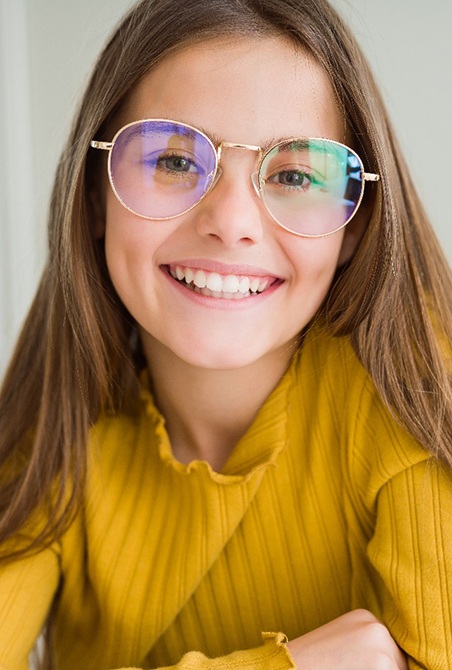 Smiling pre-teen girl with glasses and tooth-colored fillings in Wylie