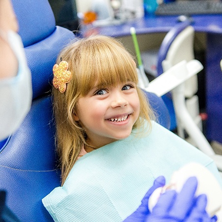Girl smiling in the dental chair